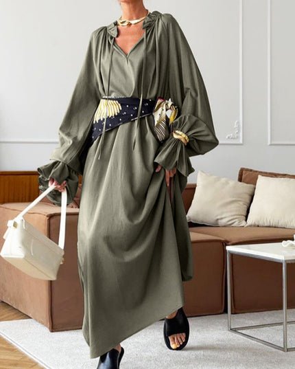 Woman wearing a green dress in a living room setting