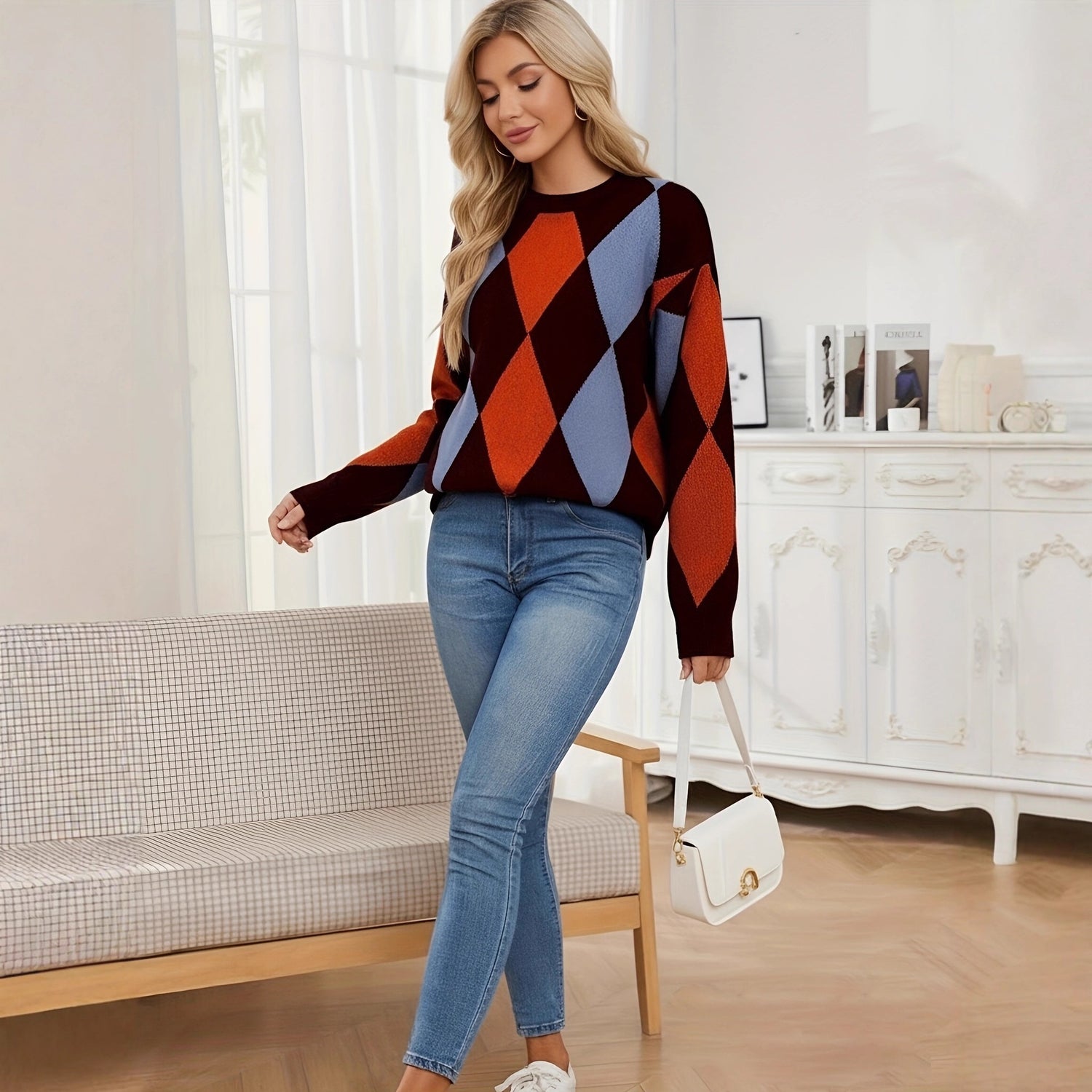 Woman wearing a colorful argyle sweater and blue jeans in a living room.