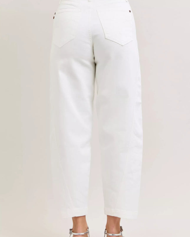 White jeans worn by a person on a plain background