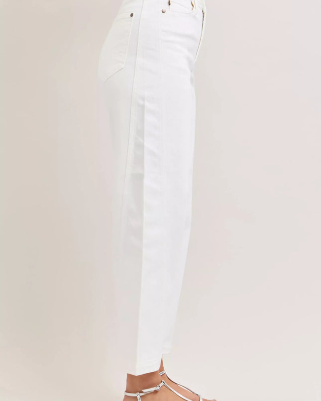 White jeans worn by a person on a light gray background