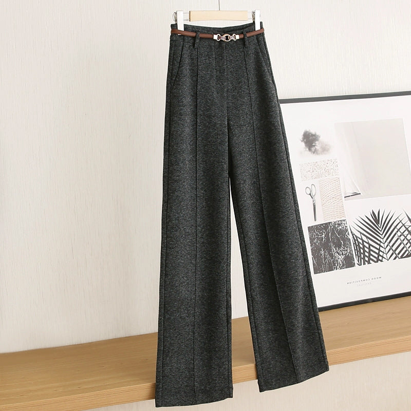 Dark gray wide-leg pants on a hanger against a neutral wall.