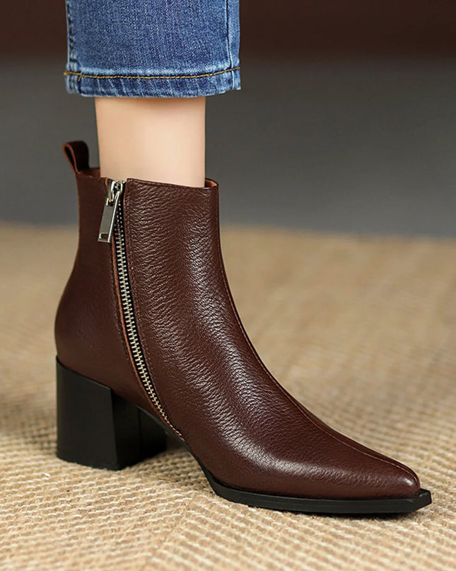 Brown ankle boot with a zipper on a textured surface