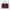 Red textured handbag with black handles and tags on a light gray background