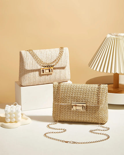 Two straw handbags with gold chains on a light beige background