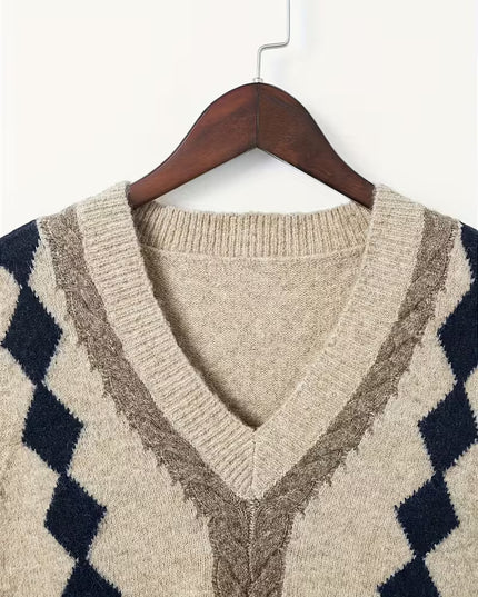 Beige sweater with geometric pattern on a hanger against a white background