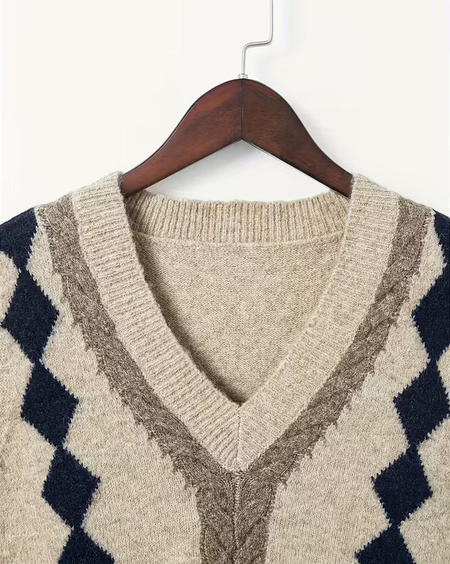 Beige sweater with geometric pattern on a hanger against a white background