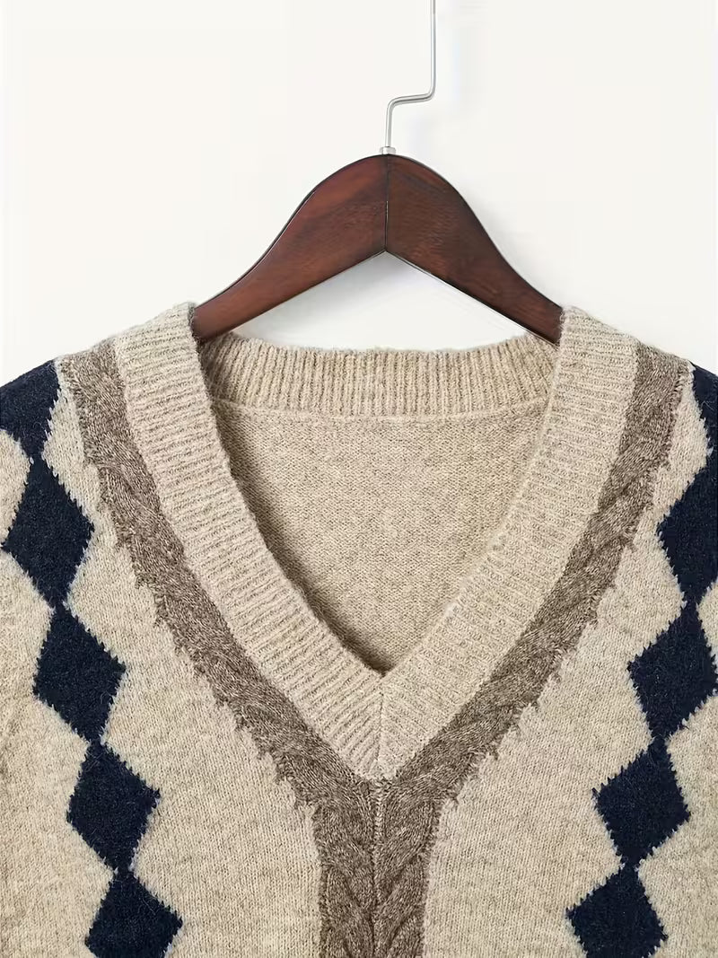 Beige sweater with geometric pattern on a hanger against a white background