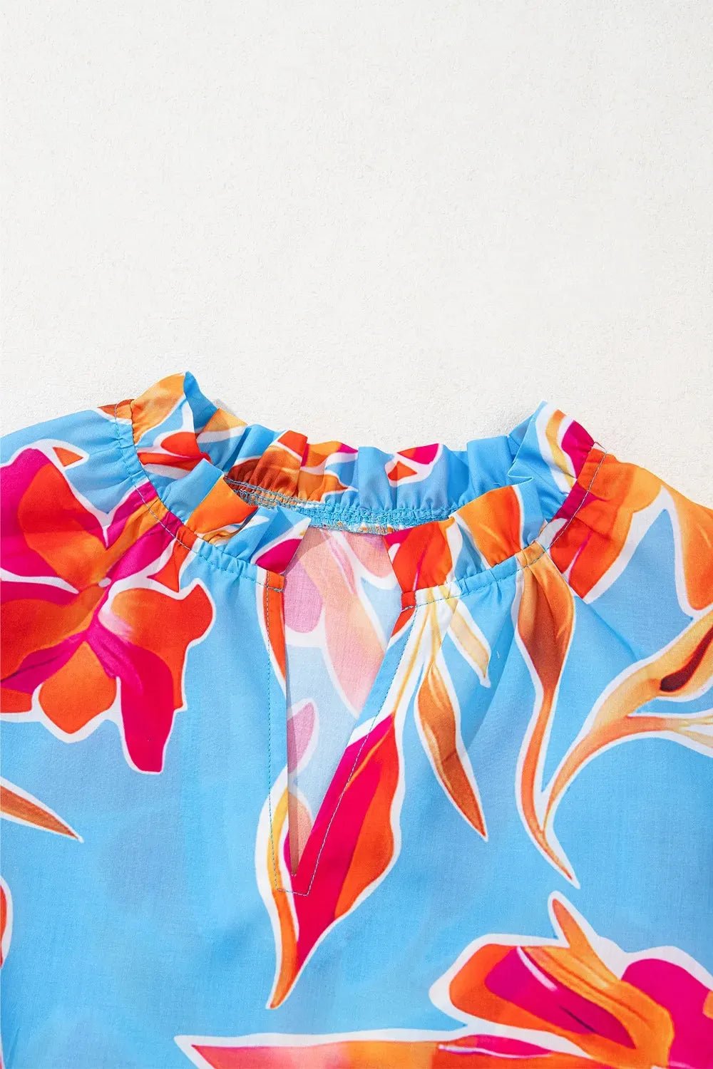 Floral Flutter Sleeve Blouse with Pompom Trim.